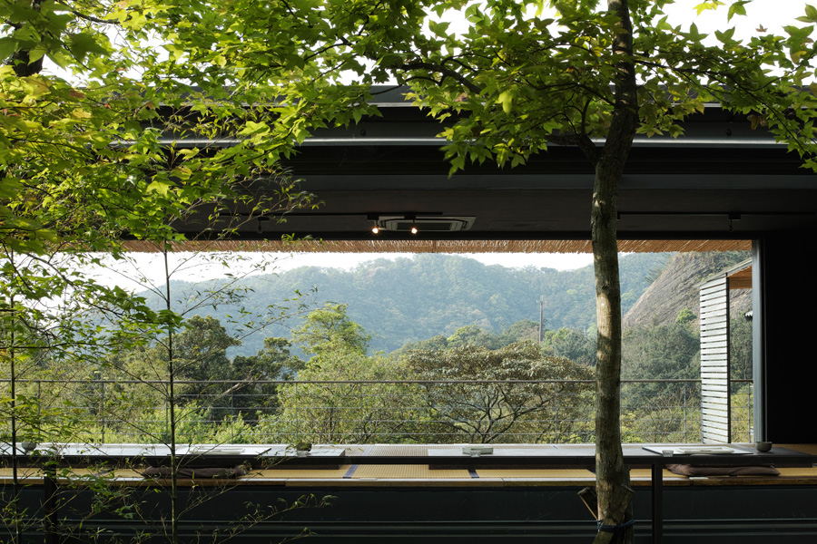 A restaurant with a spacious open layout and views over a mountain landscape.